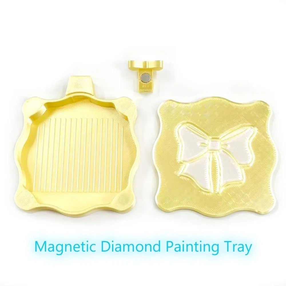 A yellow magnetic diamond painting tray with a lid and a separate bowknot organizer piece.