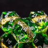 A close-up of a set of green resin dice with golden elven numbers, angled against a dark background.