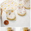 A set of five soft cotton muslin baby washcloths featuring various floral and sun patterns arranged on a white surface.