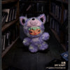 A purple and green plush doll pendant from the Hirono After Dark Series mystery blind box displayed on a wooden shelf.