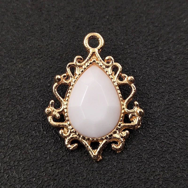 Gold plated water droplet charm featuring a white crystal rhinestone flower detail.