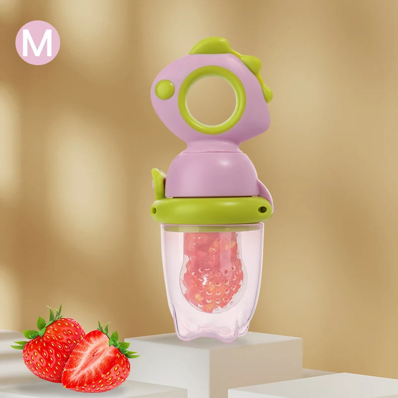 A purple and green dinosaur-shaped silicone feeder for babies containing red fruit pieces.