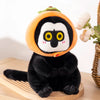 A cute black and orange capybara plush toy with large eyes sitting on a wooden surface.
