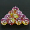 A pyramid of ten glitter polyhedral dice in mixed colors resting on a dark surface.