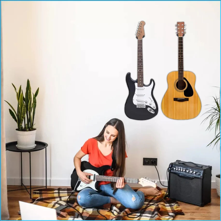 A person is playing a white guitar in front of a wall display featuring several guitars mounted on wood panels.