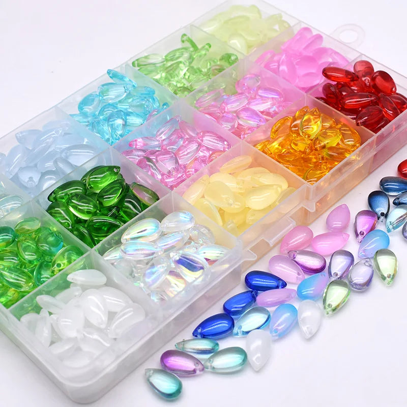 A collection of colorful water drop Czech glass beads in various shades including green, blue, pink, and yellow.