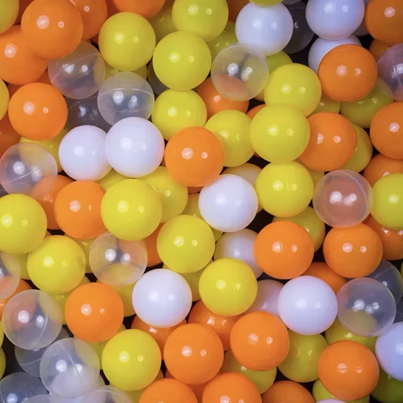 A close-up view of a large pack of colorful plastic balls in various shades of orange, yellow, and white.