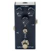 A black guitar effects pedal with gain and level controls, featuring an output switch.