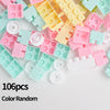 A pile of 106 random colored plastic stacking blocks in various shades of pink, yellow, and mint green.