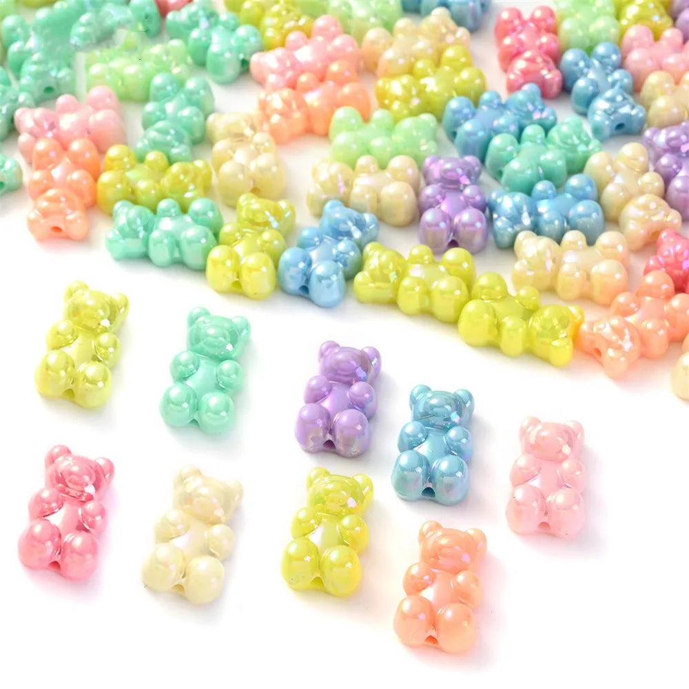 A pile of pastel bear-shaped acrylic craft beads in various shades of pink, green, yellow, and purple.