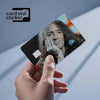 A hand holds a square card sticker featuring a portrait of Jimi Hendrix, used as a Rock Band decal.