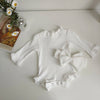 White ribbed long-sleeve romper outfit set for a toddler girl with a matching bow headband