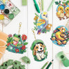 A collection of animal owl diamond painting keychains and craft materials laid out on a white surface.