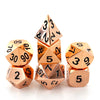 A set of three premium metal polyhedral dice with a gold finish arranged in a pyramid shape.