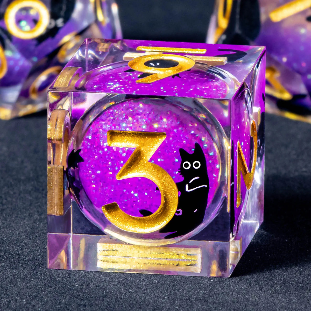 A purple liquid core resin die set featuring the number 3 and a cat silhouette, with gold accents.