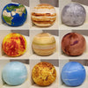 A collection of spherical plush toys representing planets, including Earth, Mars, and Jupiter, displayed in various colors.