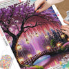 A diamond painting kit featuring a vibrant landscape of a flowering tree, glowing lanterns, and a bridge at night.