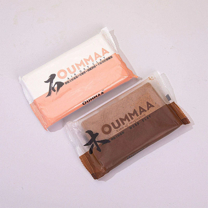 A package of OUMMAA air-dry clay in a light pink/tan color, showing the brand name and product description.