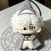 A soft collectible plush doll of a character wearing a gray witch hat and a gray coat, sitting on a diagram.