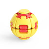 A yellow and red spiral design fidget ball toy with a cap.