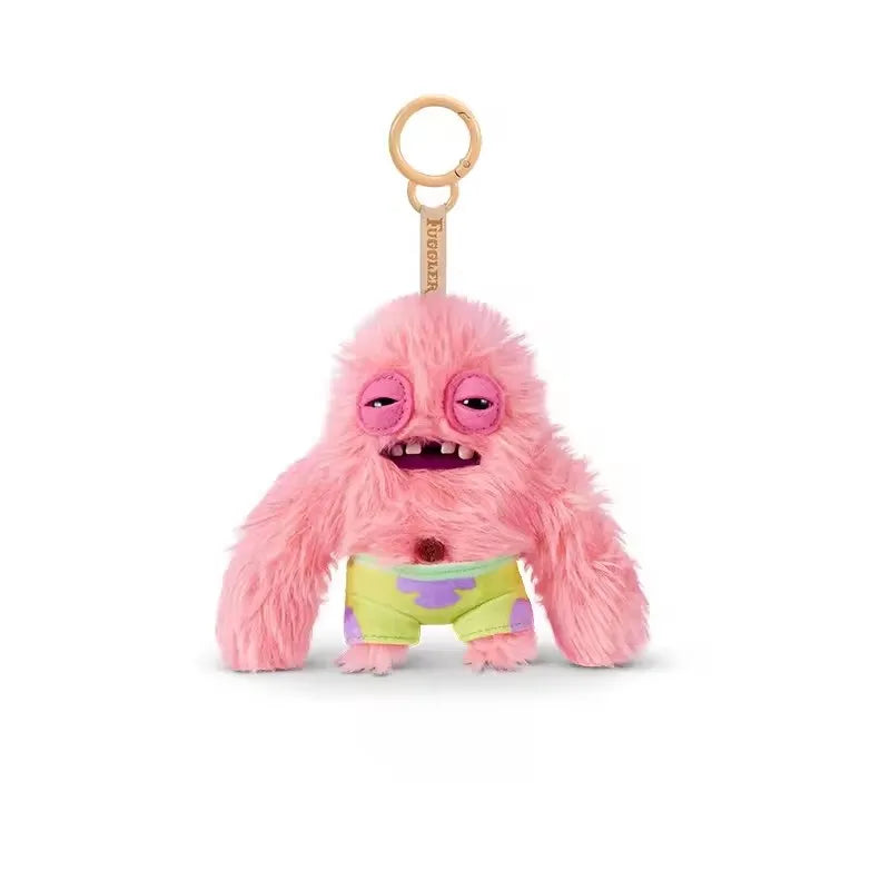 Pink fuzzy monster plush keychain with a round head and green shorts
