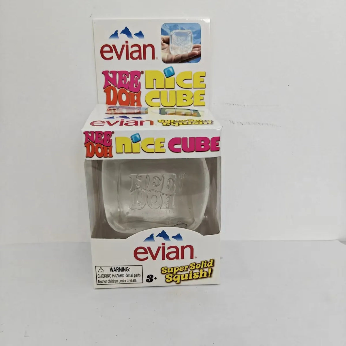 A box and clear silicone cube of the evian Nee Doh Cube fidget toy for stress relief and sensory play.