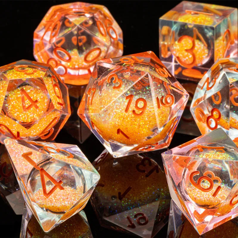 A collection of translucent orange and pink liquid core dice set for tabletop gaming