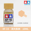 Tamiya XF-15 flat flesh acrylic paint in a glass bottle, labeled for model building.