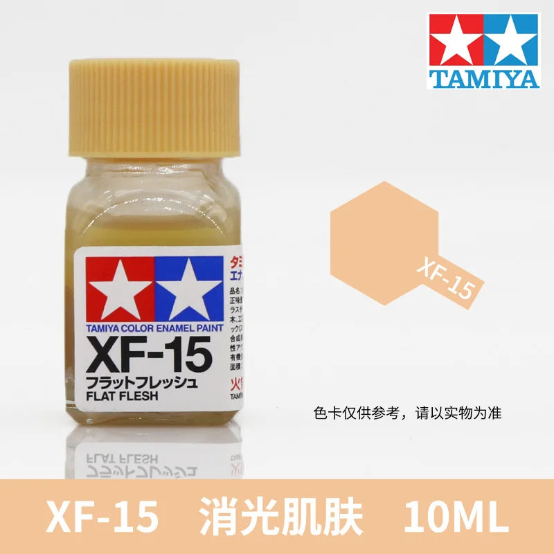 Tamiya XF-15 flat flesh acrylic paint in a glass bottle, labeled for model building.