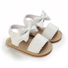Pair of white breathable baby first walker sandals with bow details and soft anti-slip soles