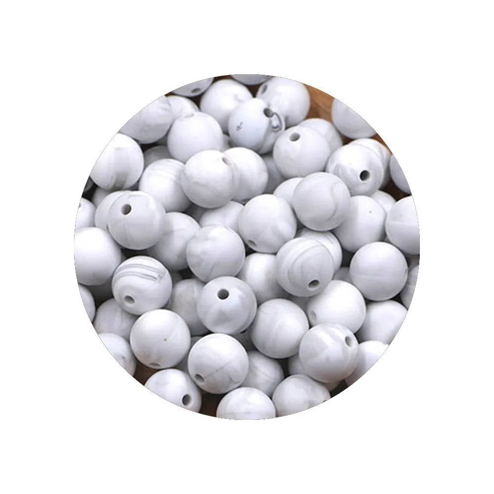 A pile of assorted white silicone beads for DIY jewelry making