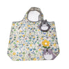 A light-colored fabric pouch with a floral pattern featuring a gray hippo plush toy.