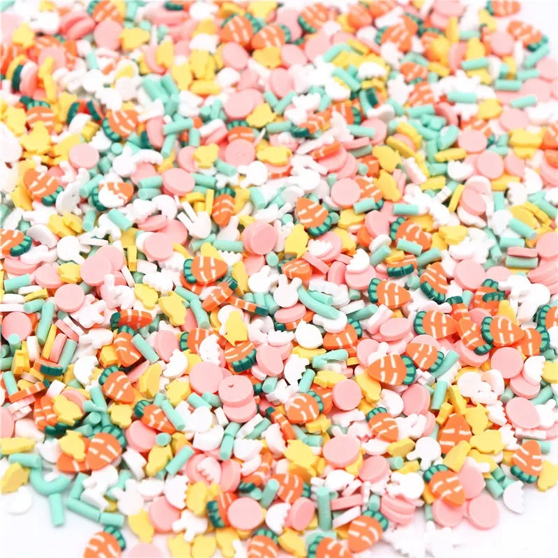 A pile of colorful polymer clay flower charms in various shades including pink, orange, yellow, and green.