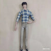A poseable plush doll figure wearing a blue and white plaid shirt and gray pants, standing against a light background.