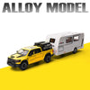 A yellow diecast model of an Alloy Model RV camper truck on a yellow surface.