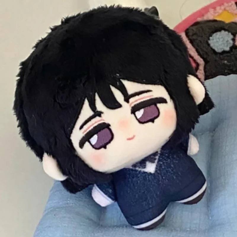 A plush keychain set featuring a black-haired character with purple eyes and a dark blue outfit.