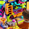 A child plays with a colorful multi-layer rolling ball track adventure toy featuring bright plastic components.