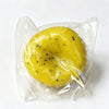 A yellow watermelon kiwi squishy stress ball fidget toy is visible inside a clear plastic bag.