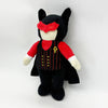 A black plush toy resembling a rabbit with red ears and a red shirt featuring a gold symbol.