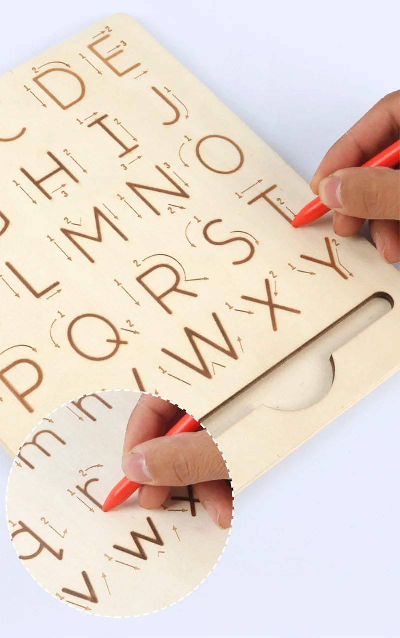 A hand is tracing letters on a wooden Montessori letter tracing board for early learning.