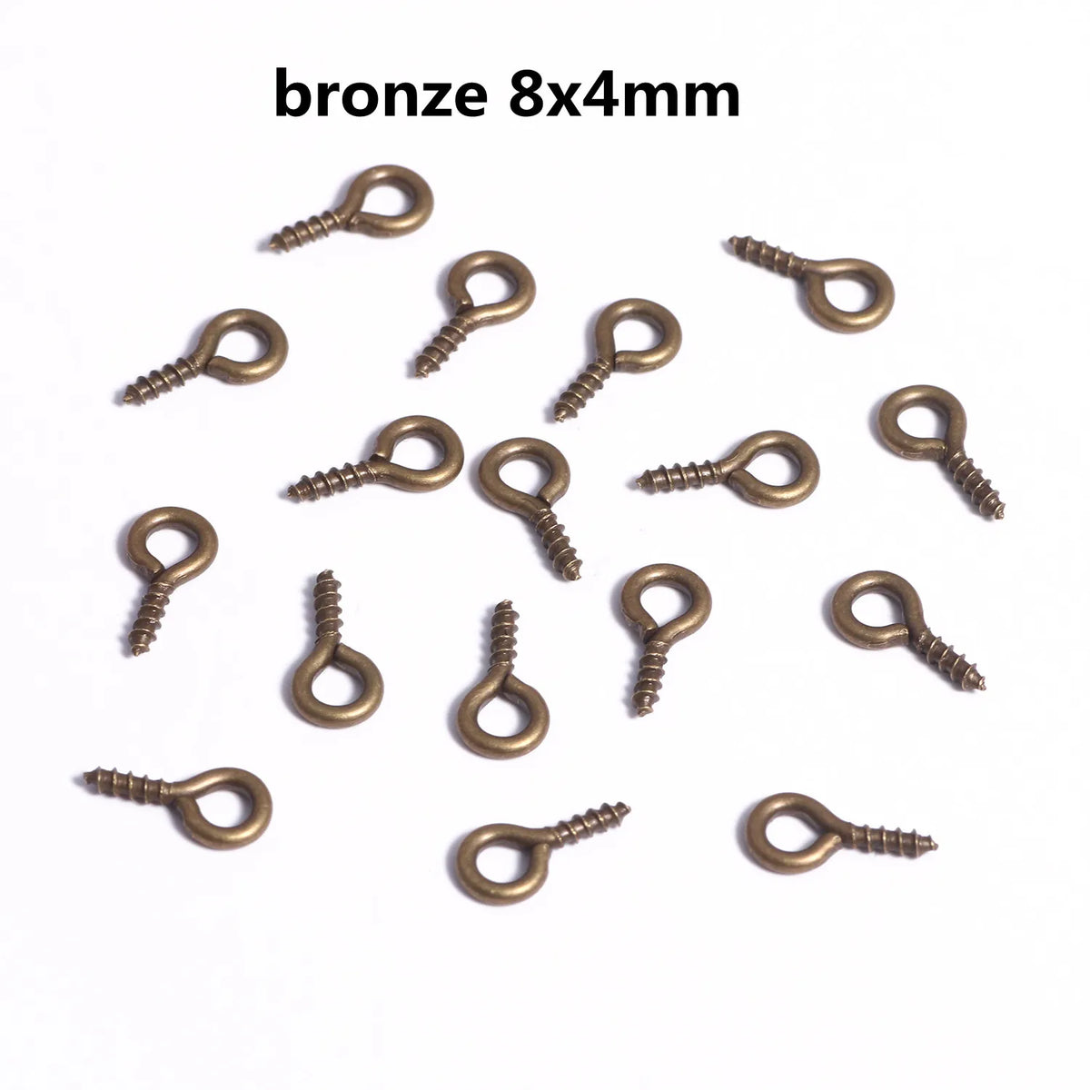 A collection of bronze 8x4mm mini eye pins with screw threads for jewelry making.
