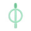 A light green silicone baby teether with an easy-grip ring and a textured top.
