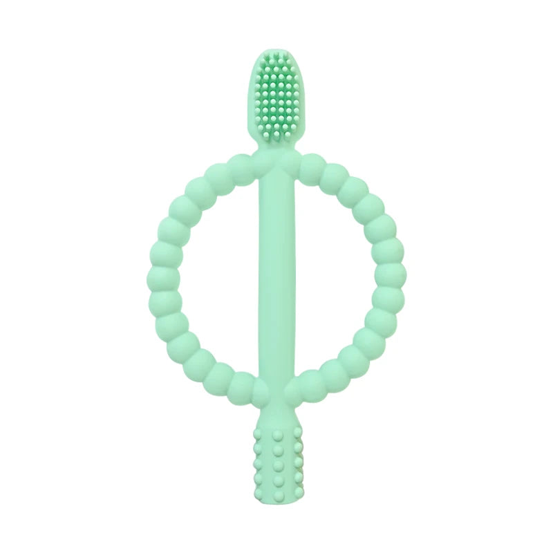 A light green silicone baby teether with an easy-grip ring and a textured top.