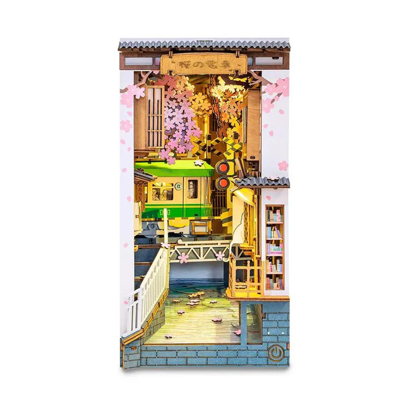 A miniature dollhouse kit featuring a traditional Japanese-style building with pink blossoms and wooden details.