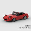 A red classic rally car model built from LEGO bricks, shown in a side view.