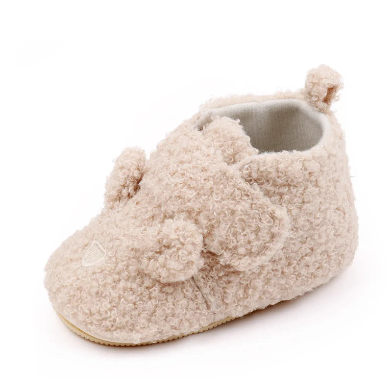 A pair of light beige fuzzy bear design baby prewalker shoes with a soft anti-slip sole.