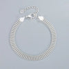 A sterling silver snake chain bracelet for women with a clasp and heart charms.