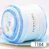 A spool of light blue and white gradient yarn for knitting and crochet