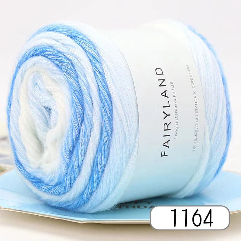 A spool of light blue and white gradient yarn for knitting and crochet
