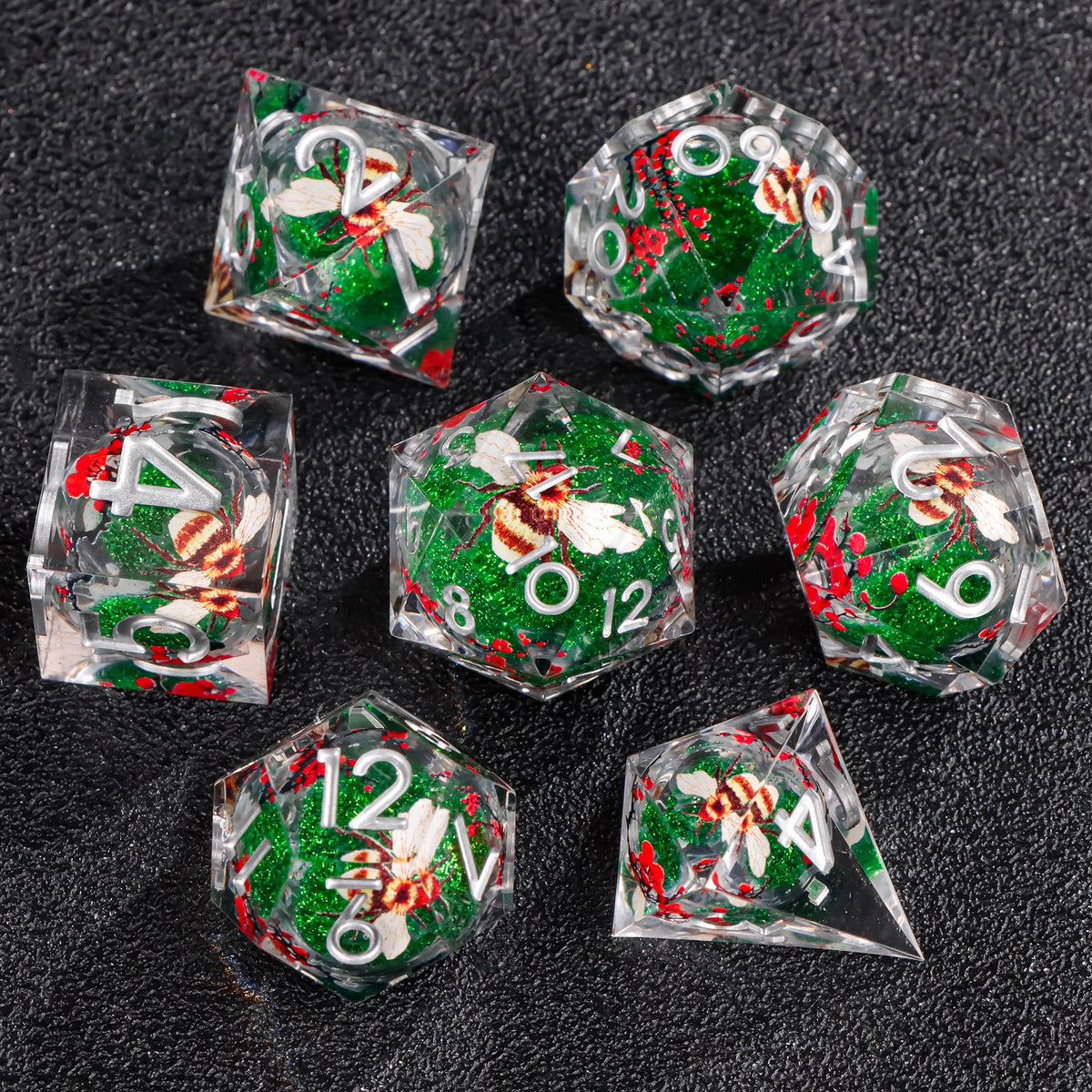A set of liquid core polyhedral dice featuring green and red glitter with white and red patterns on a black surface.